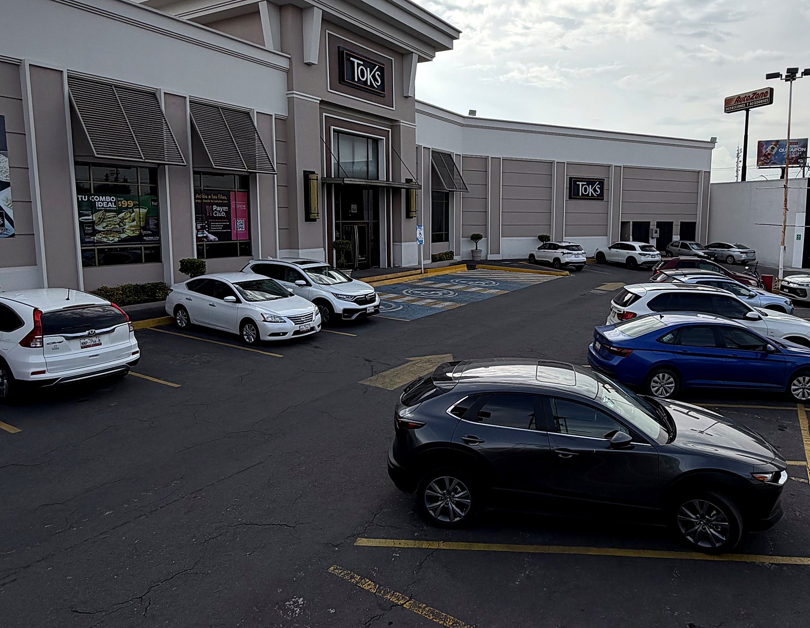 Shopping plaza parking with an anchor restaurant, operated by SIE PARK